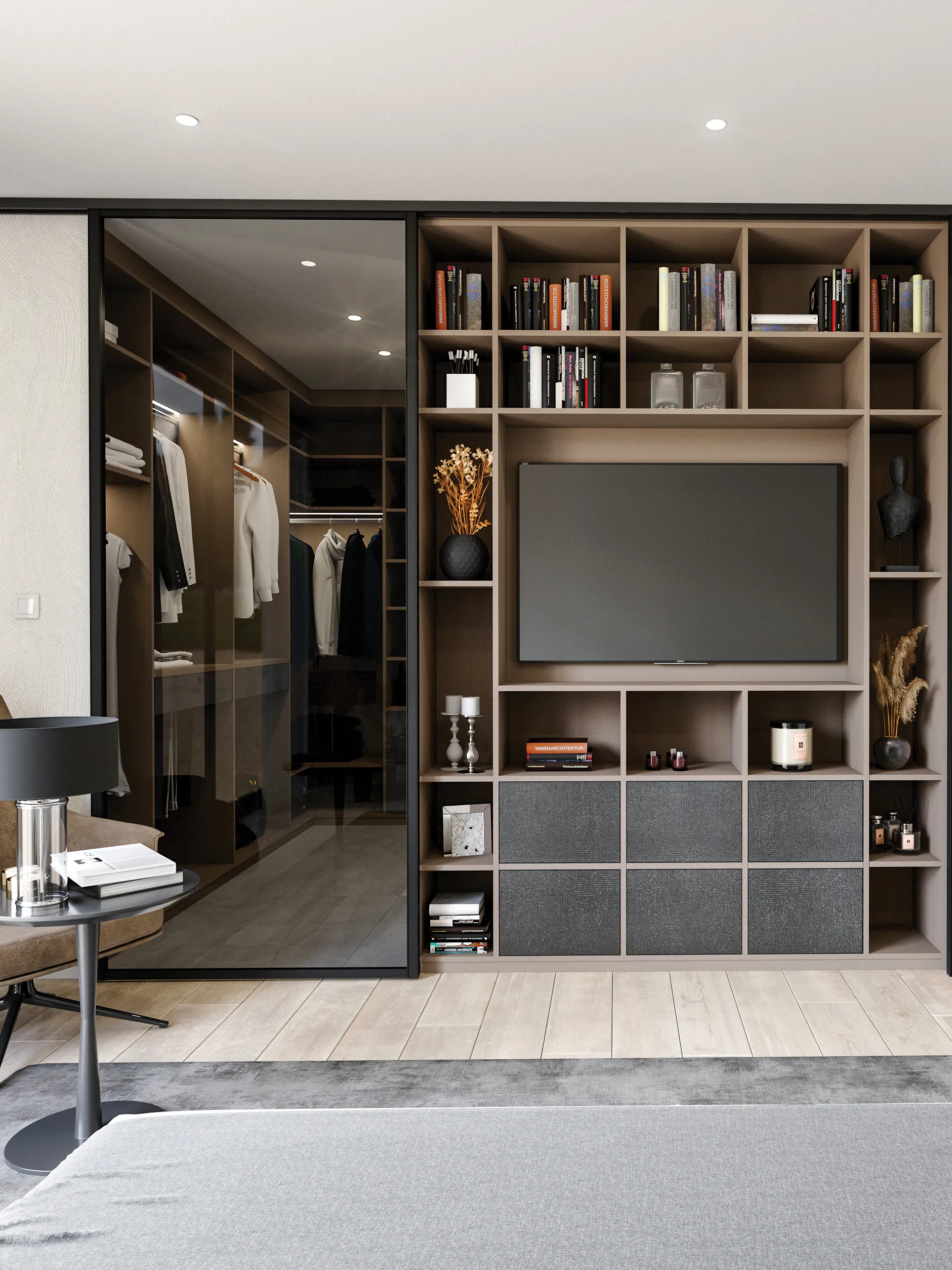 Suite parentale avec meuble TV sur mesure, bibliothèque intégrée, rangements bas texturés et accès visuel vers un dressing fermé par façade vitrée.