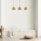 Banquette blanche avec suspensions en fibres naturelles, pouf texturé et décoration épurée dans un intérieur lumineux.