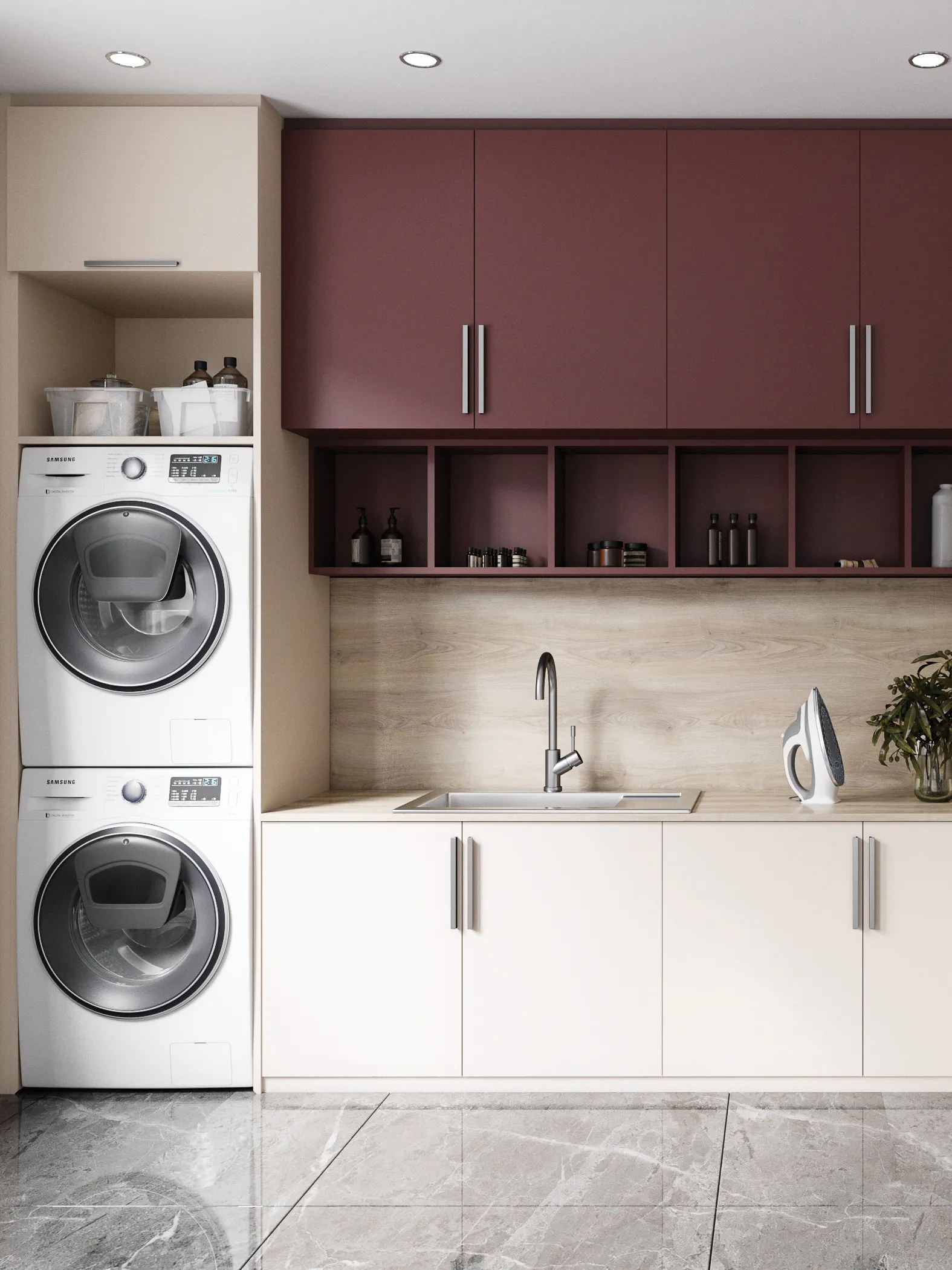 Buanderie aménagée sur mesure avec lave-linge et sèche-linge superposés, meubles crème et bordeaux, évier intégré et niches ouvertes pour le rangement.