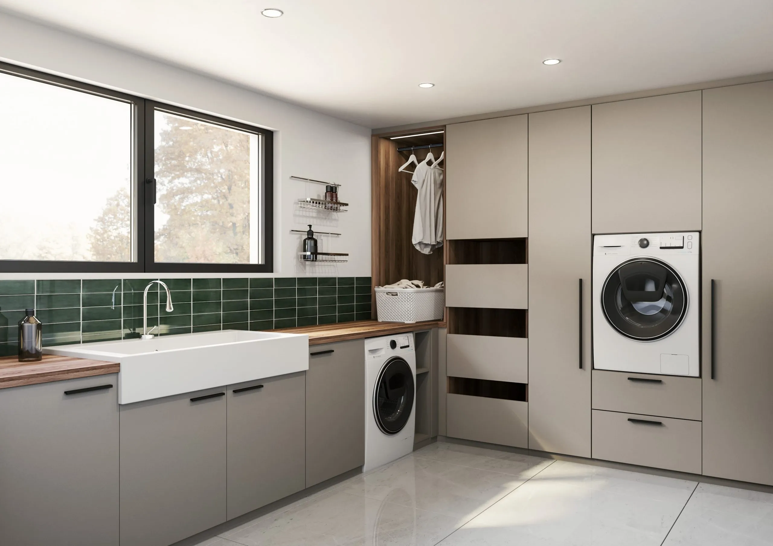 Buanderie sur mesure avec évier, lave-linge, armoire haute, tiroirs coulissants et crédence vert foncé.