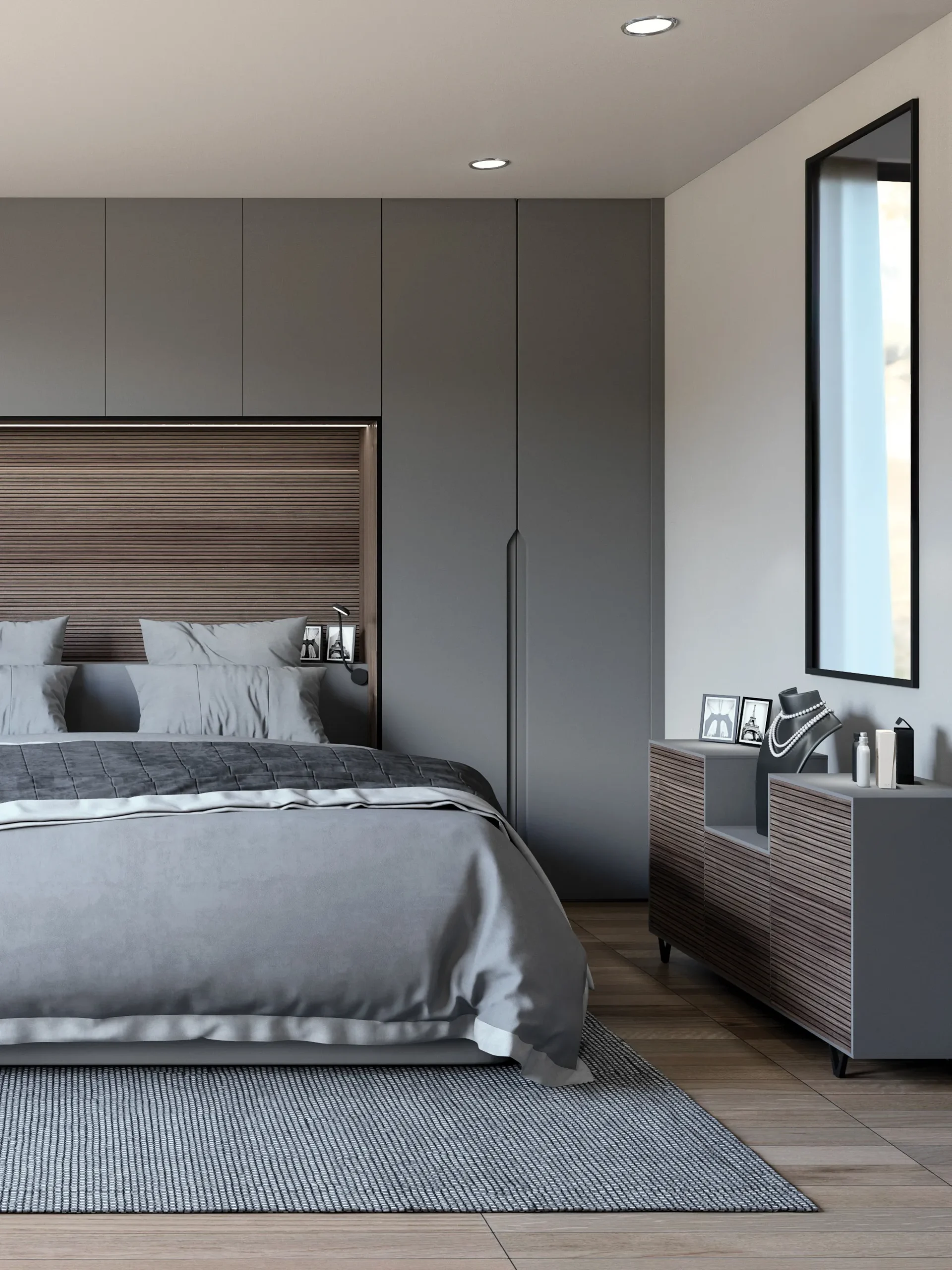 Chambre contemporaine avec grands placards intégrés gris, tête de lit à lames bois et mobilier coordonné pour une ambiance sobre et raffinée.